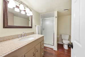 Bathroom featuring a vanity with a light-toned countertop, an undermount sink, and a chrome faucet