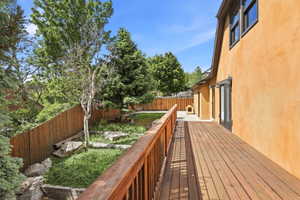 Spacious outdoor deck featuring wood-finish decking and railing