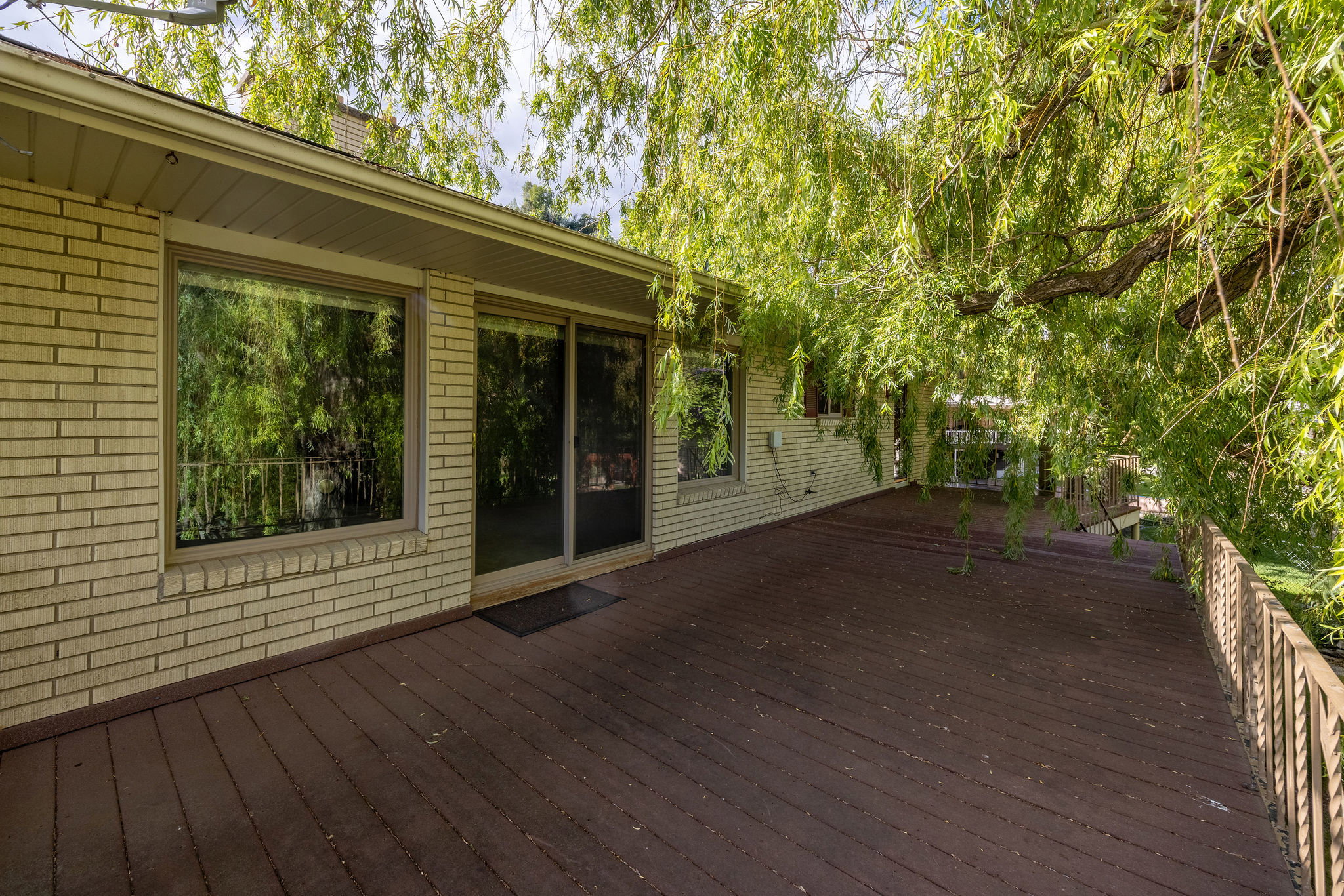 Expansive wood deck with a metal railing
