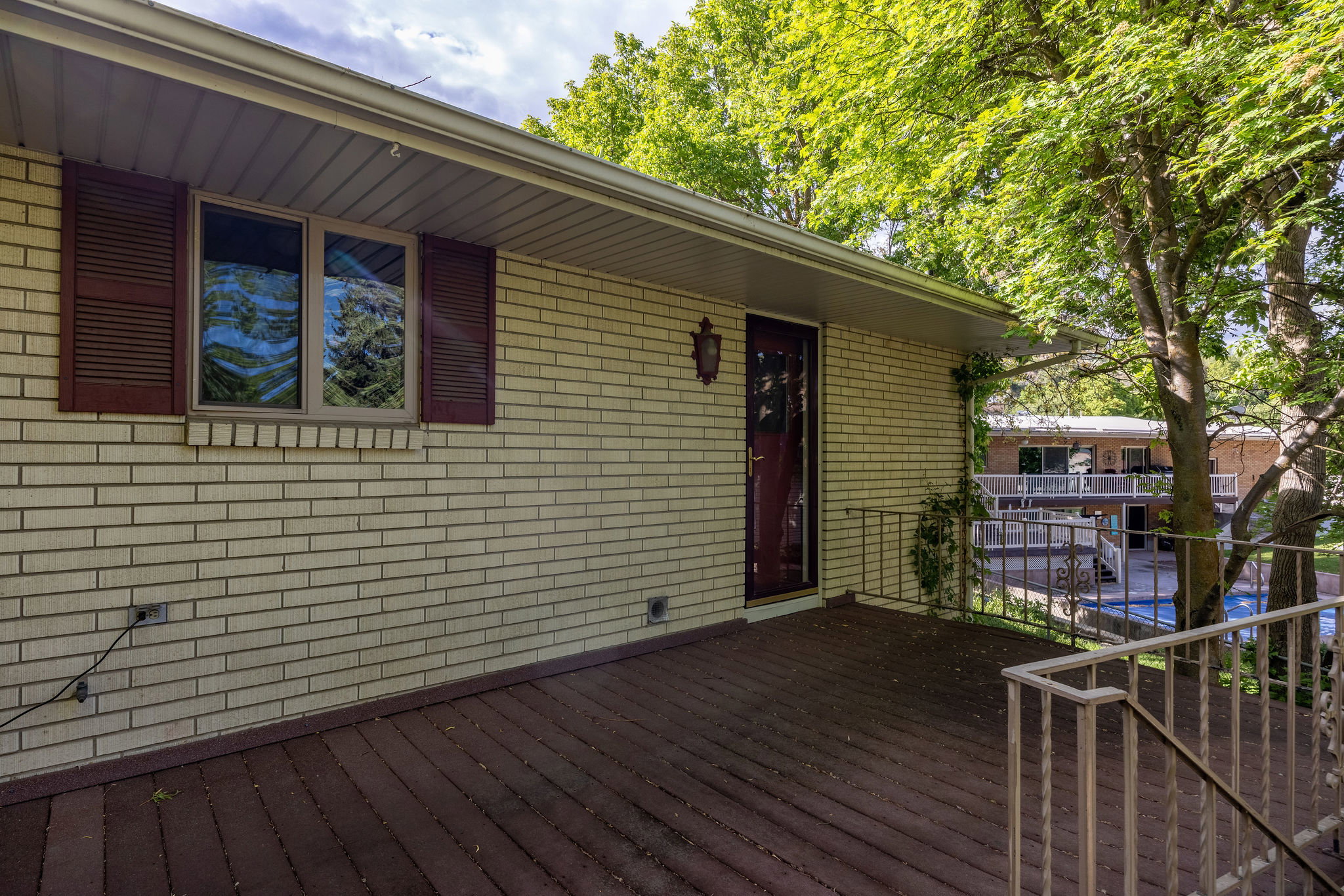 Spacious outdoor deck featuring wood-finish flooring and metal railings