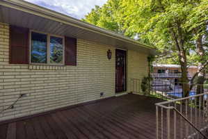 Spacious outdoor deck featuring wood-finish flooring and metal railings