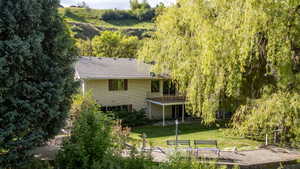Rear exterior with a second-story balcony and ground-level patio