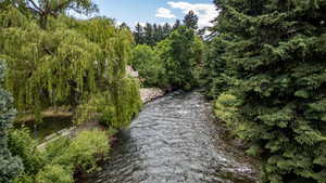 Riverfront setting featuring a flowing waterway