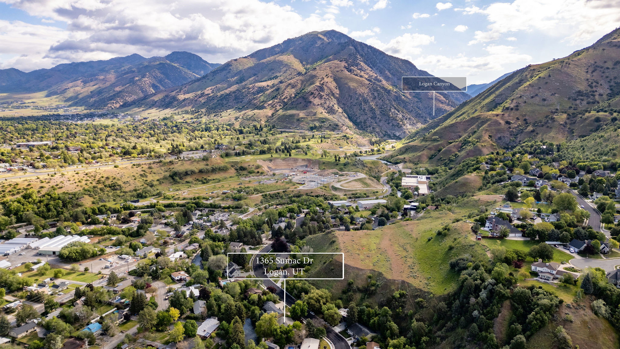 Aerial perspective showcasing a residential area nestled within a mountainous valley