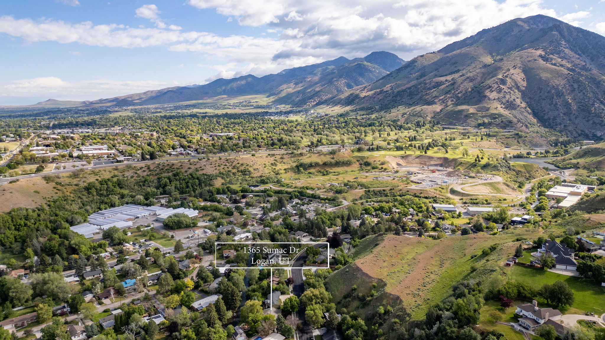 Expansive aerial perspective showcasing the property within a mountainous landscape