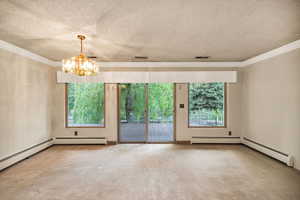 Spacious room featuring broadloom carpeting and light-toned walls