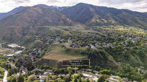 Aerial perspective showcasing a residential neighborhood nestled within a mountainous landscape