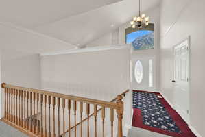 Vaulted ceiling entry with a decorative front door and sidelights