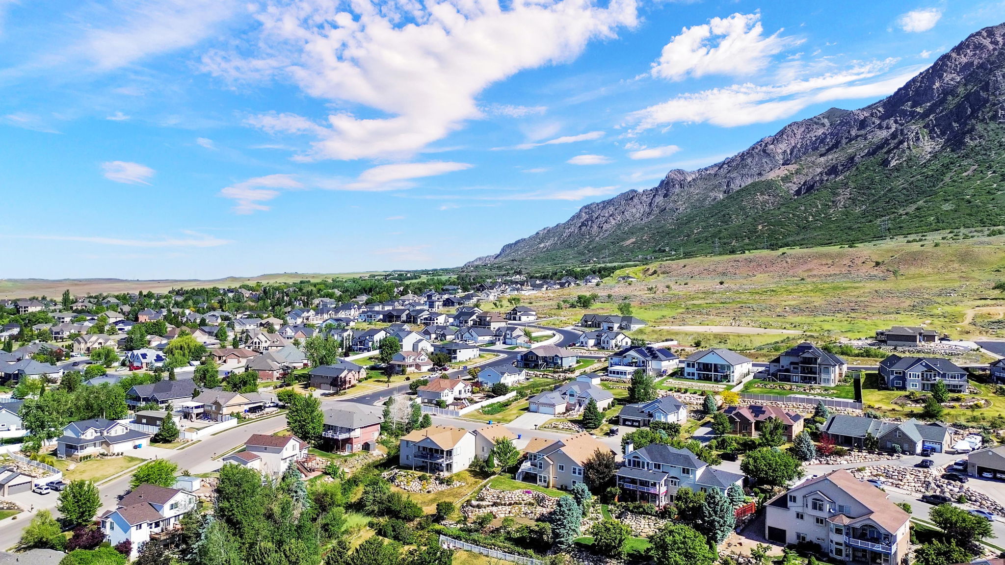 Residential neighborhood featuring a diverse collection of single-family homes with a mountainous backdrop