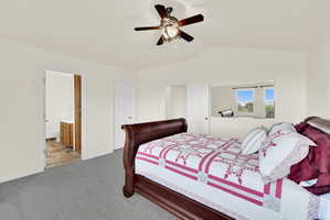 Spacious room with vaulted ceilings and gray carpet flooring