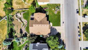 Aerial perspective showcasing a property with a distinct, terraced landscape design featuring a winding rock garden
