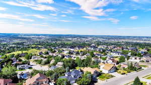 Expansive residential area featuring a variety of architectural styles, mature trees, and paved streets