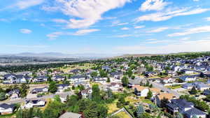 Expansive neighborhood showcasing a variety of architectural styles, mature landscaping, and clear skies overhead