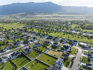 Expansive aerial view showcasing a residential neighborhood with a mountainous backdrop