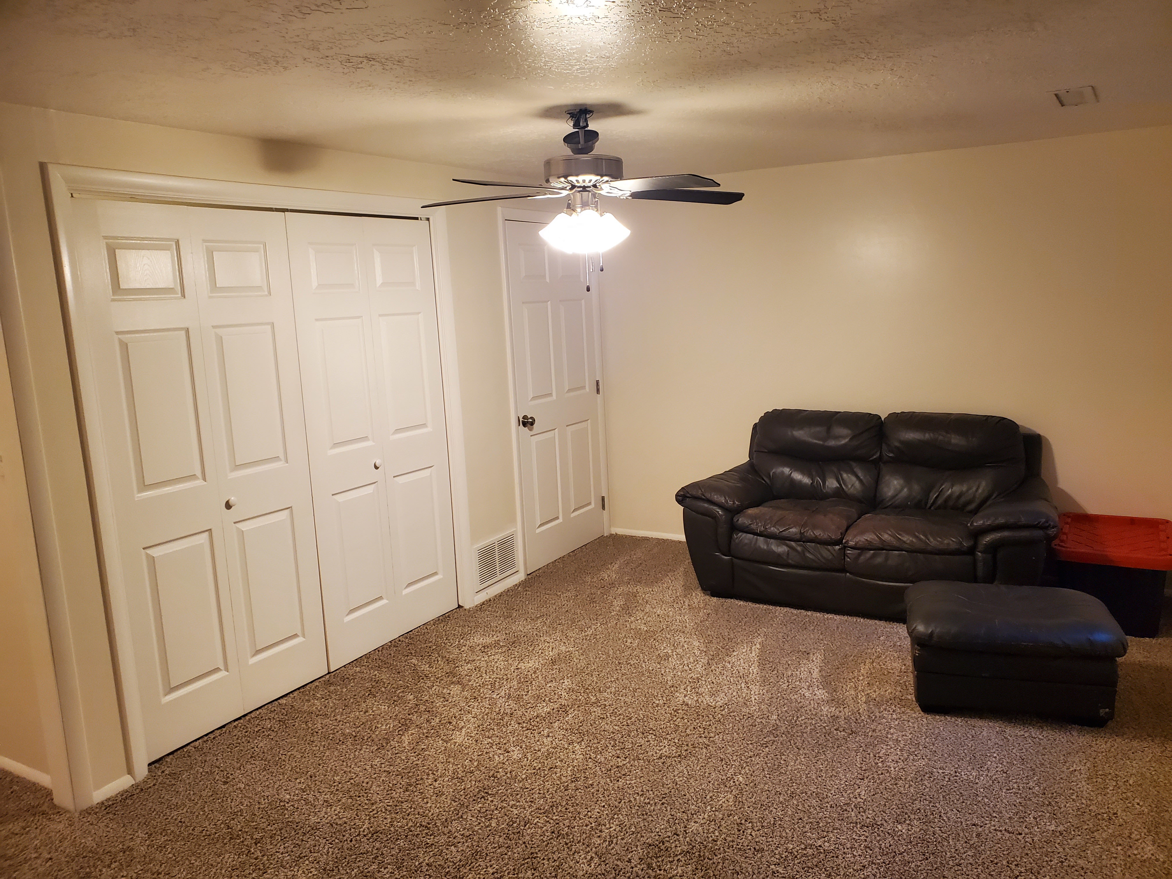 Neutral-toned wall paint complements the light brown carpeting