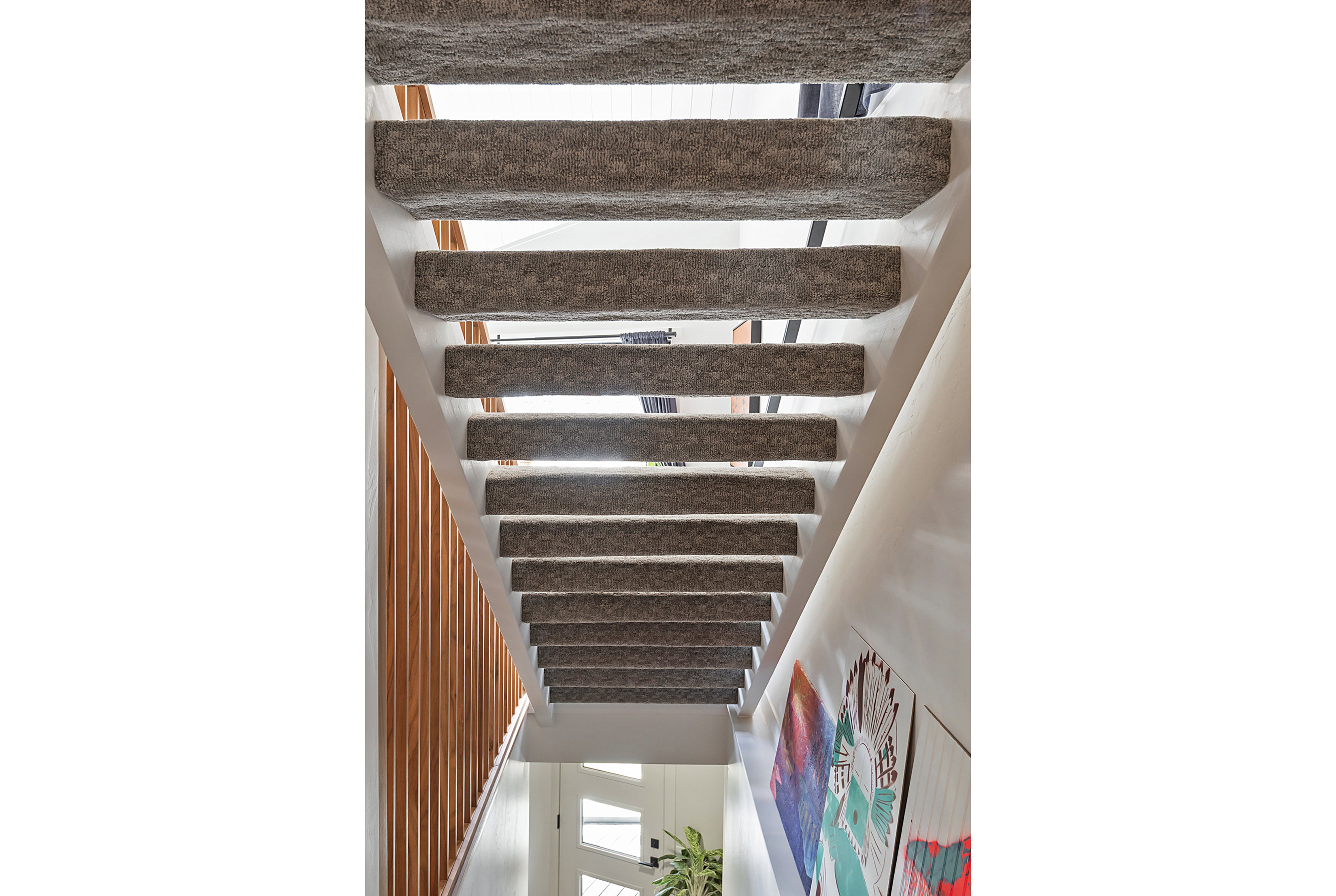 Staircase with carpeted treads and open risers