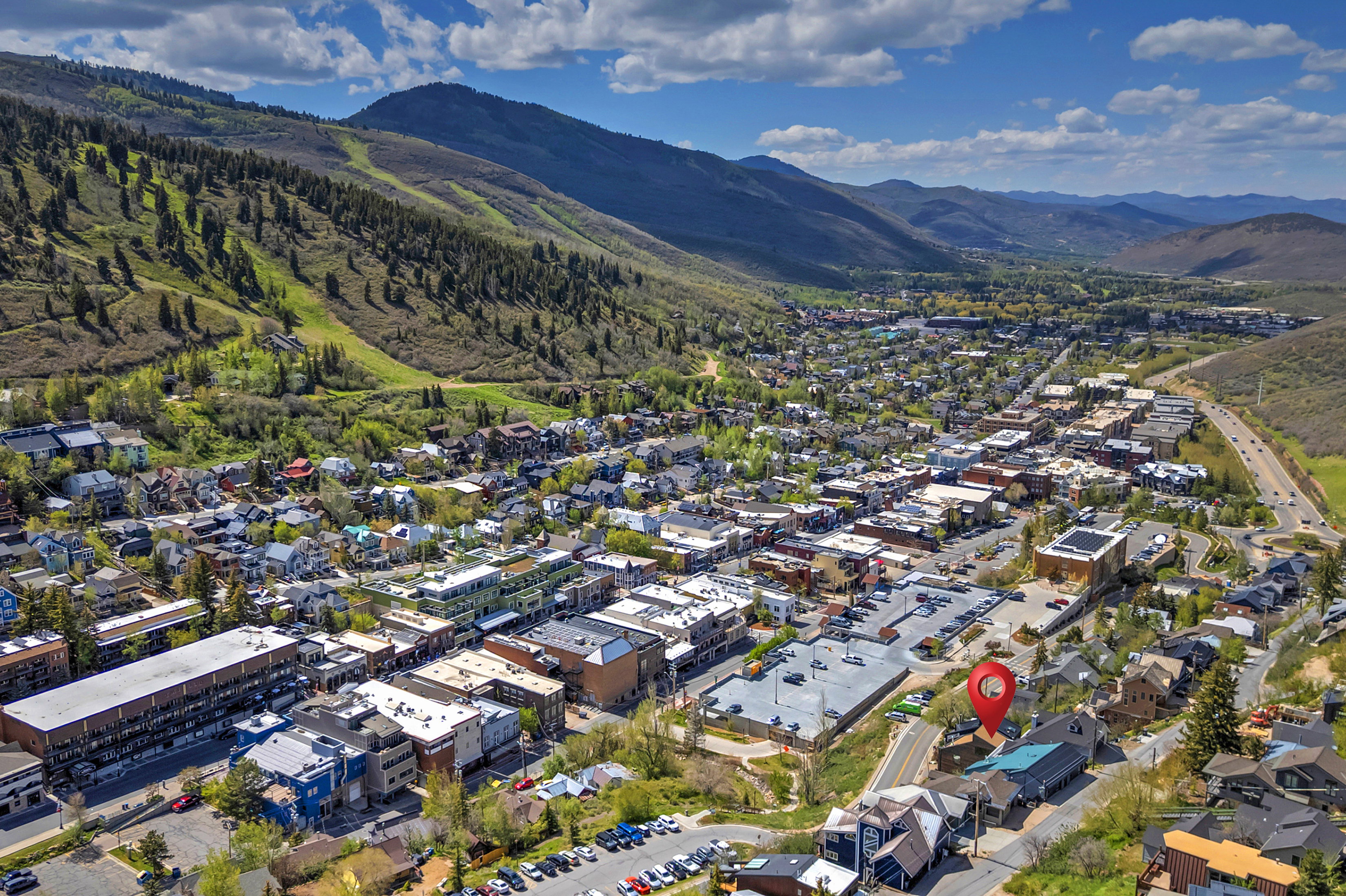 Aerial perspective of a mountain town featuring commercial and residential buildings