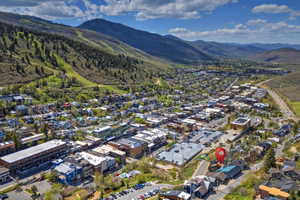 Aerial perspective of a mountain town featuring commercial and residential buildings