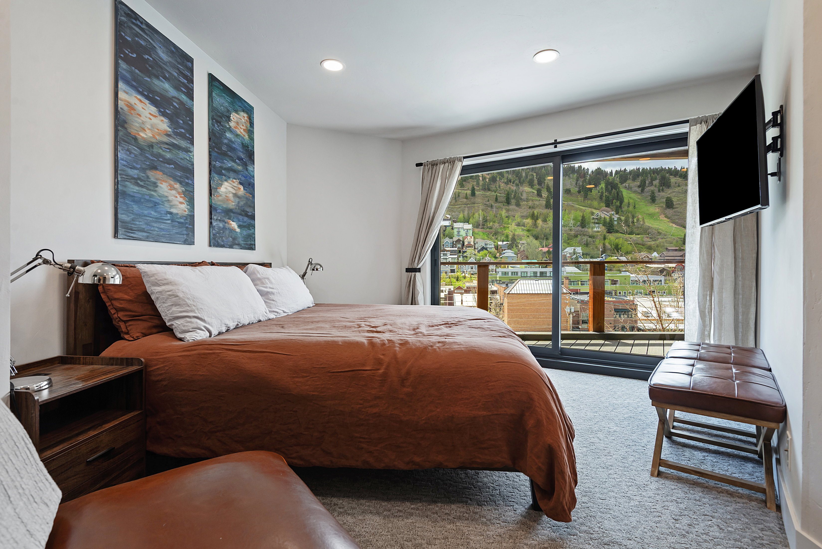 Bedroom featuring a full glass sliding door, balcony access, recessed lighting, and soft gray carpeting