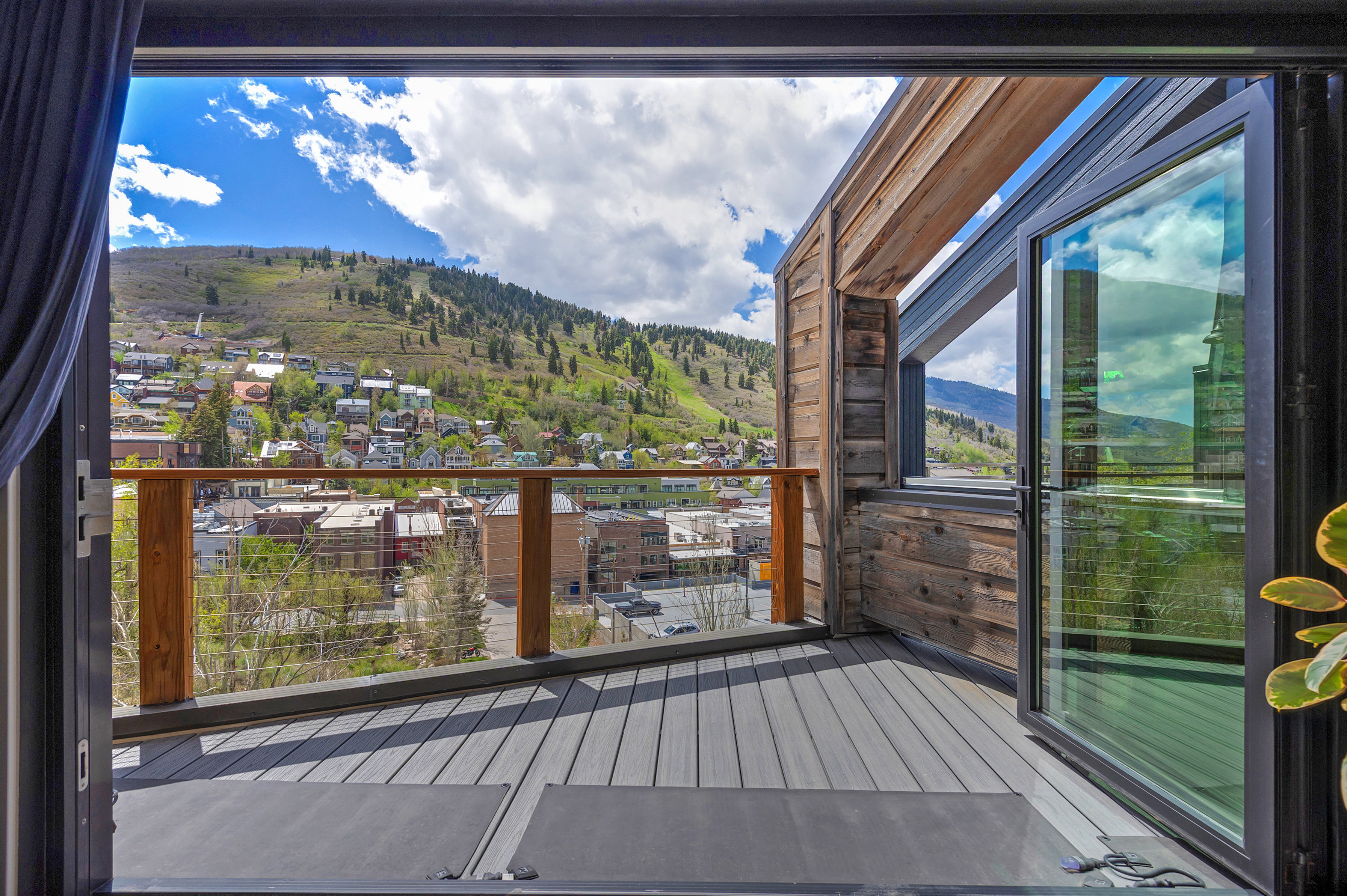 Expansive outdoor deck featuring wood-finish composite decking and a cable railing system