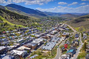 Aerial perspective highlighting a property within a mountain valley setting
