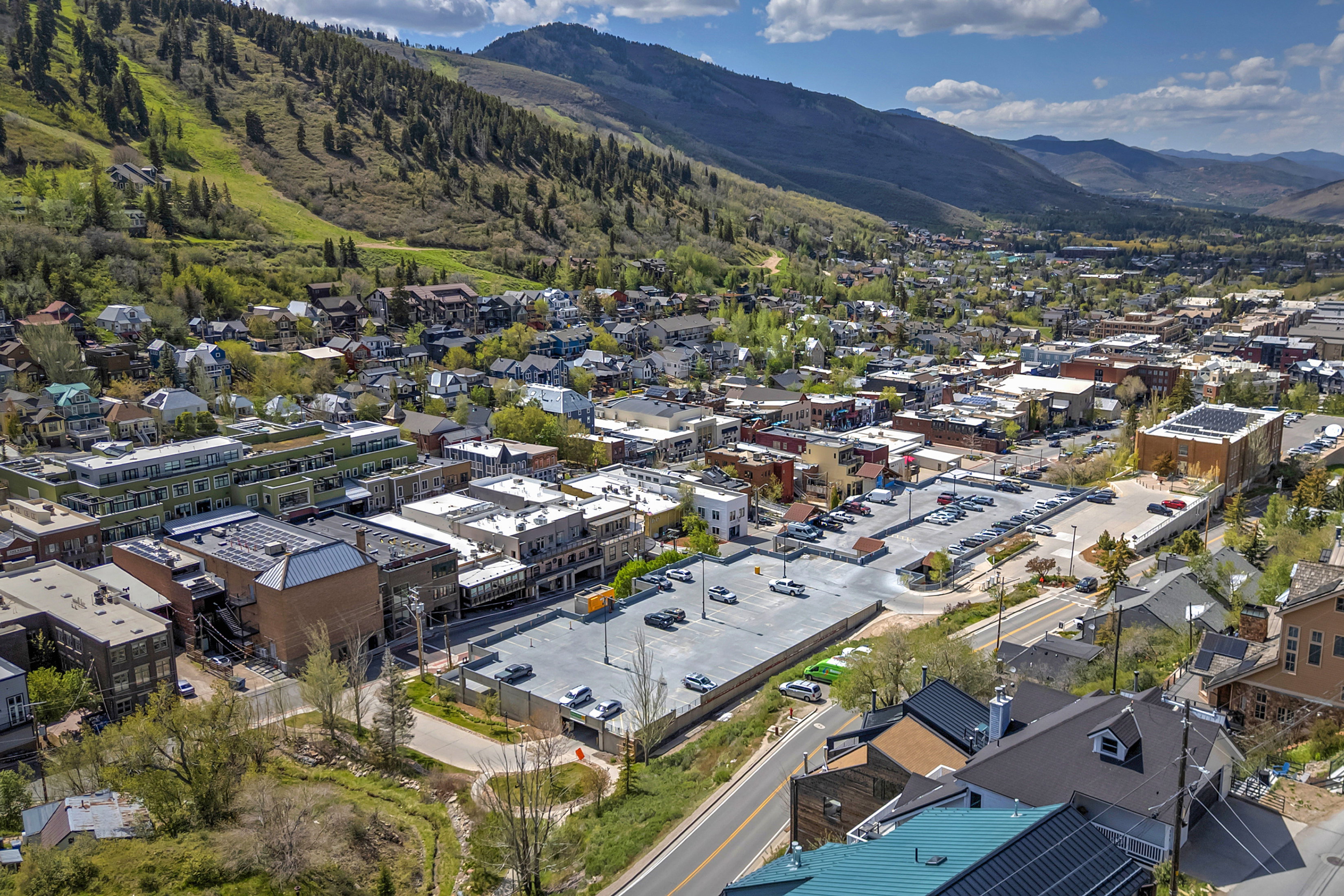 Townscape featuring multiple commercial and residential structures nestled within a mountain valley