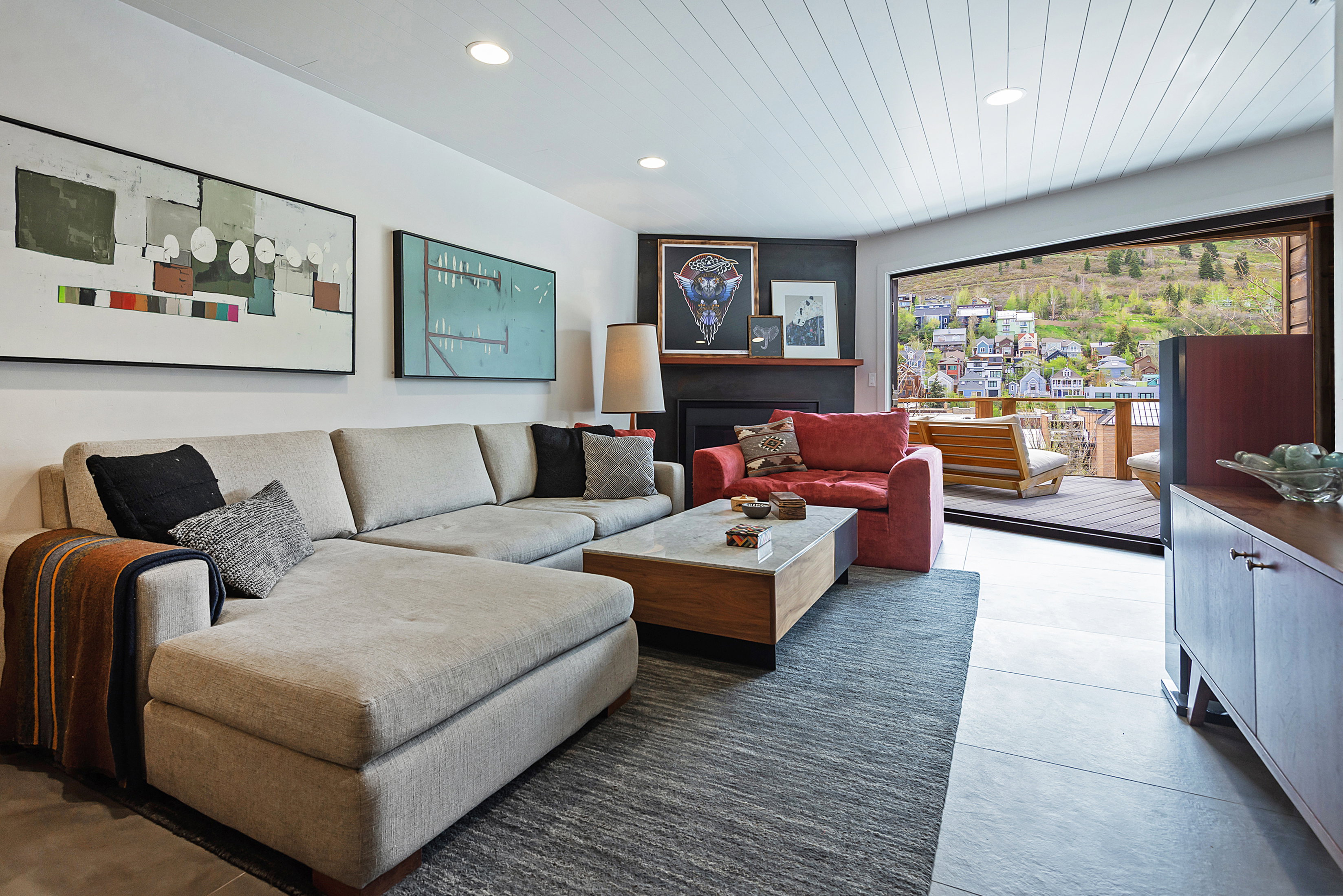 Living area featuring a shiplap ceiling, recessed lighting, and large format floor tiling