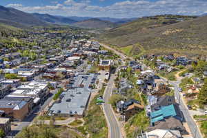 Aerial perspective of a mountain town featuring commercial and residential structures