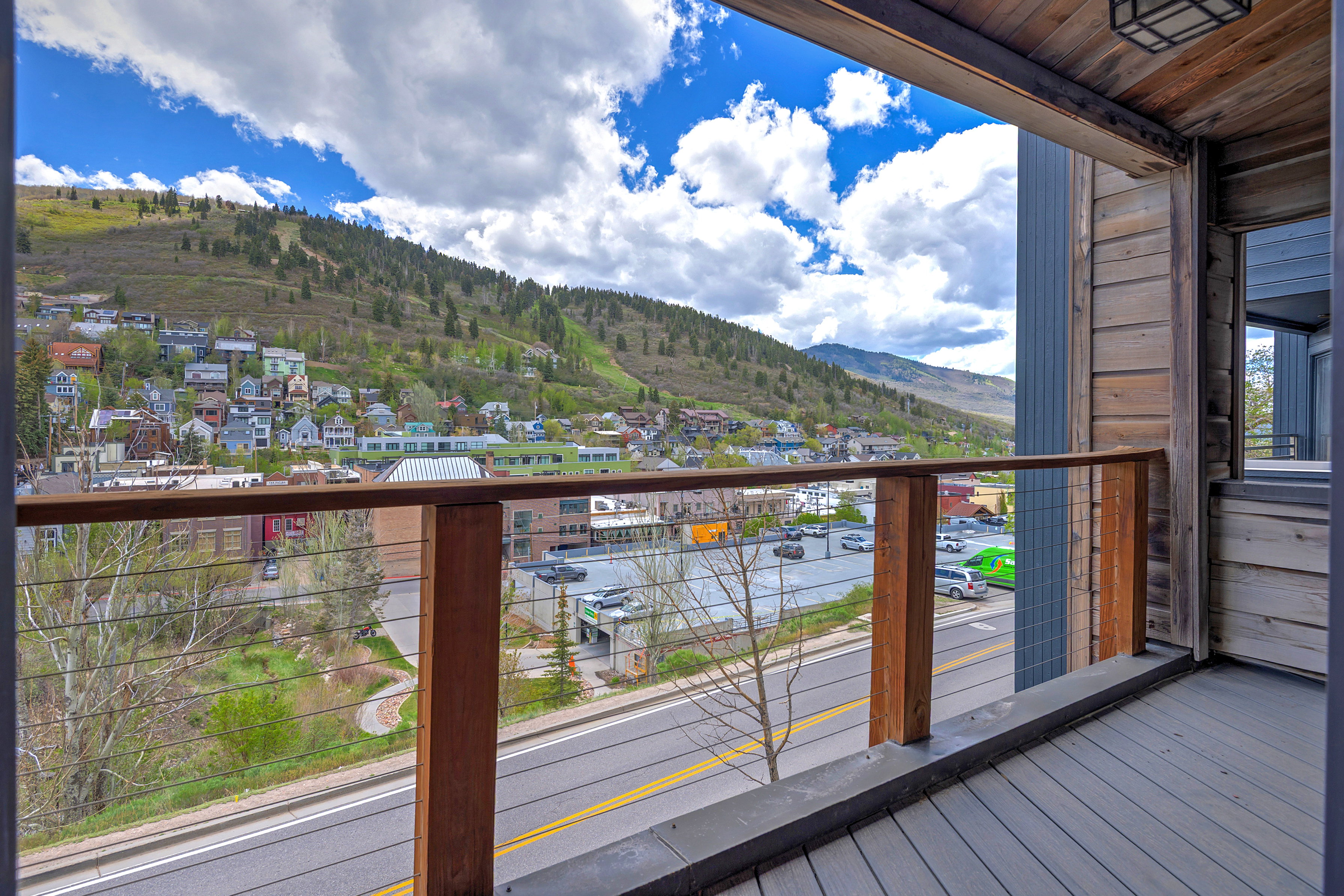 Outdoor deck featuring composite decking, wood posts, and cable railing