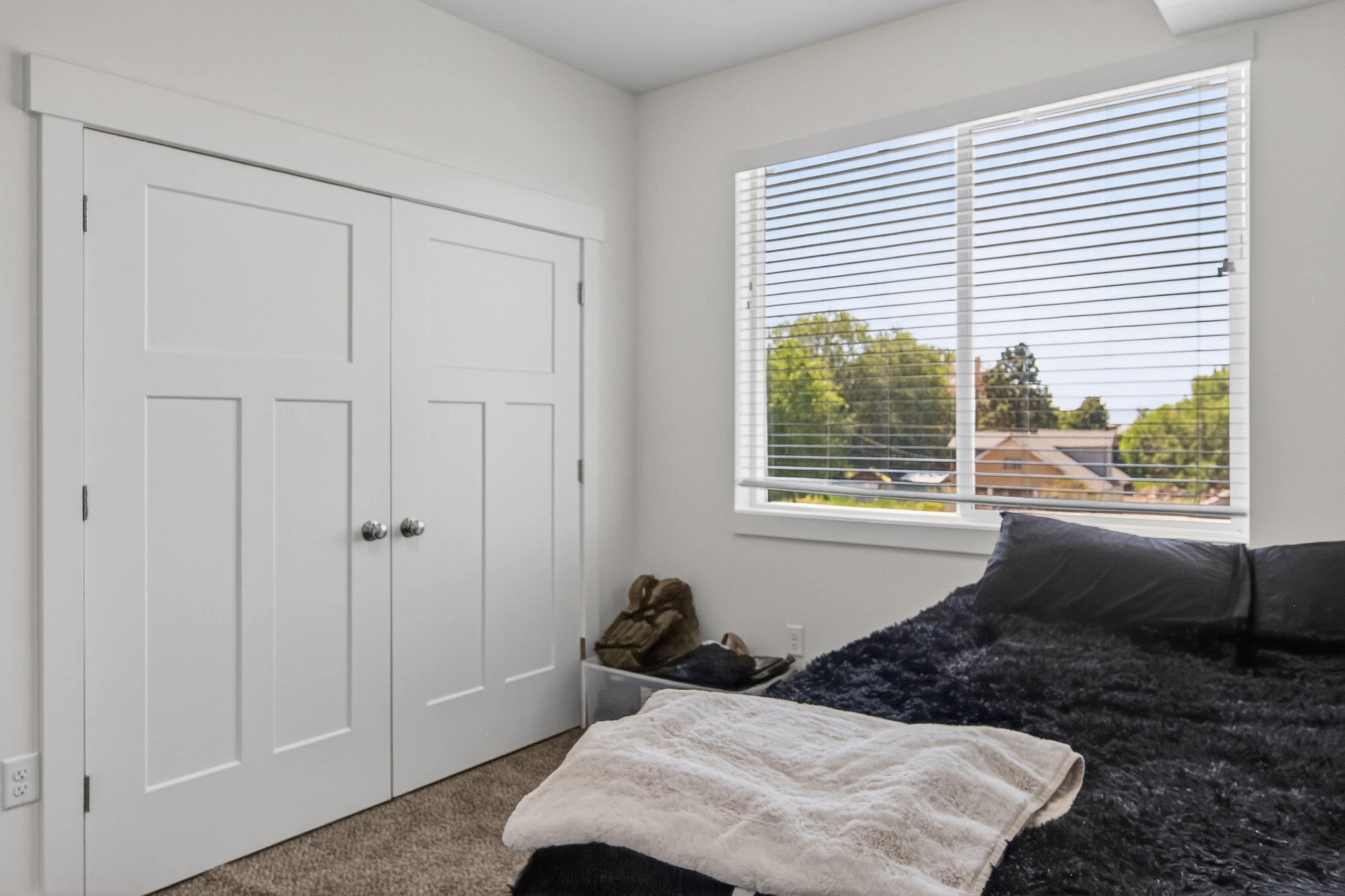Bright white walls and trim complement the light-colored carpeting