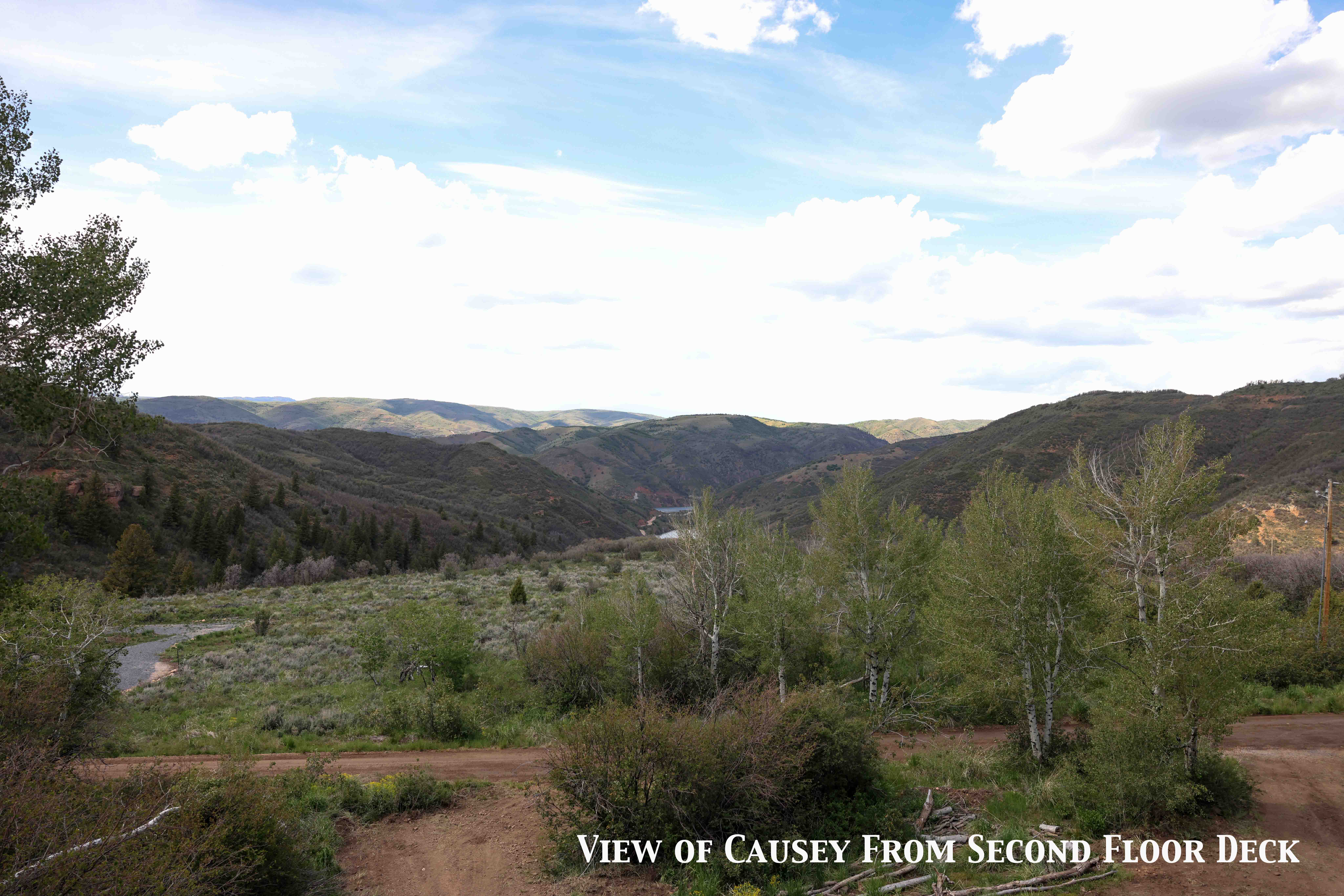 Expansive natural landscape with rolling hills and distant mountains