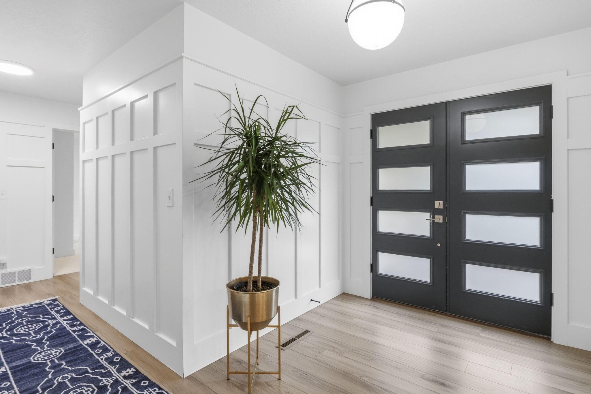 Double entry doors featuring frosted glass panels and a dark finish