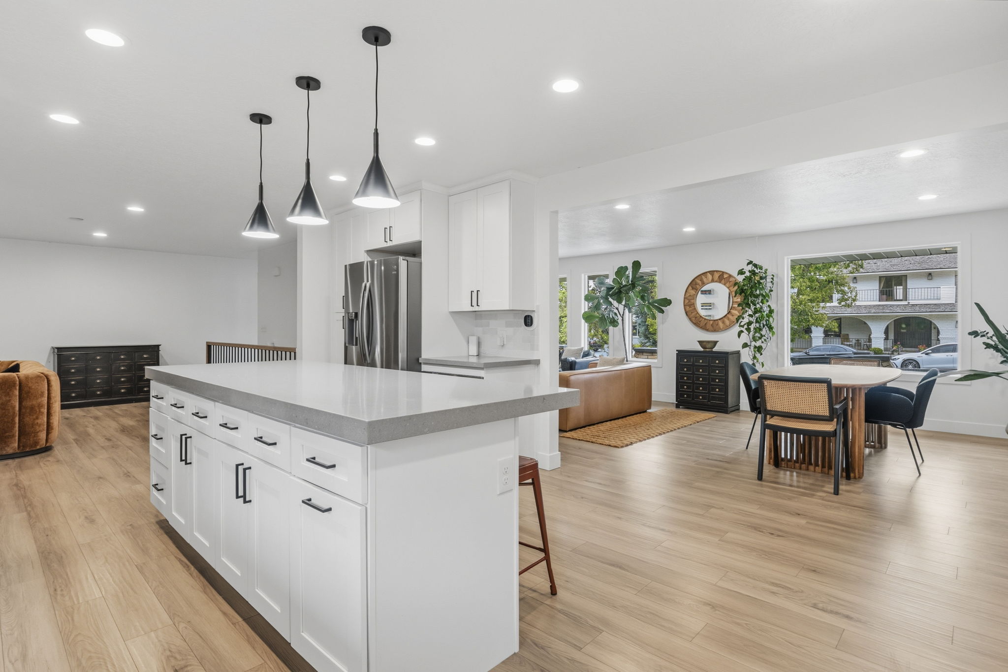 Spacious open-concept interior featuring light wood-finish flooring throughout