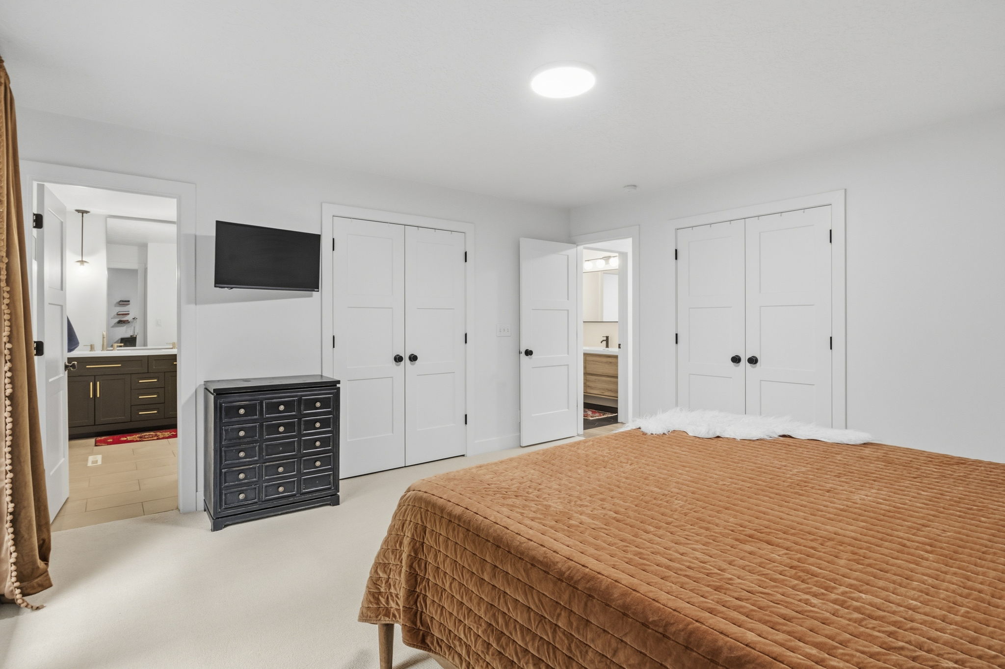 White wall finishes throughout, complemented by white interior doors featuring matte black hardware