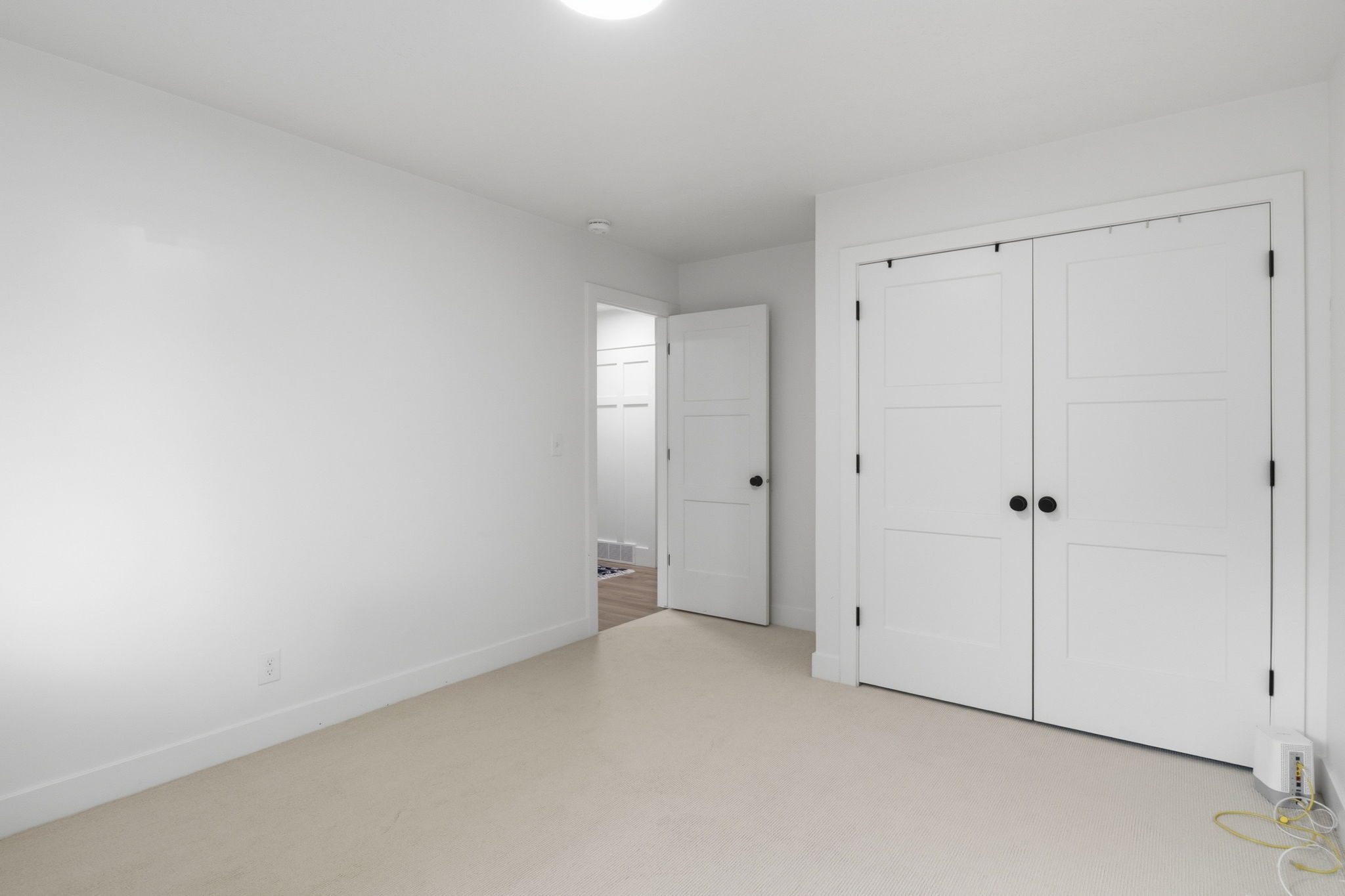 Neutral tone carpeting with white baseboards