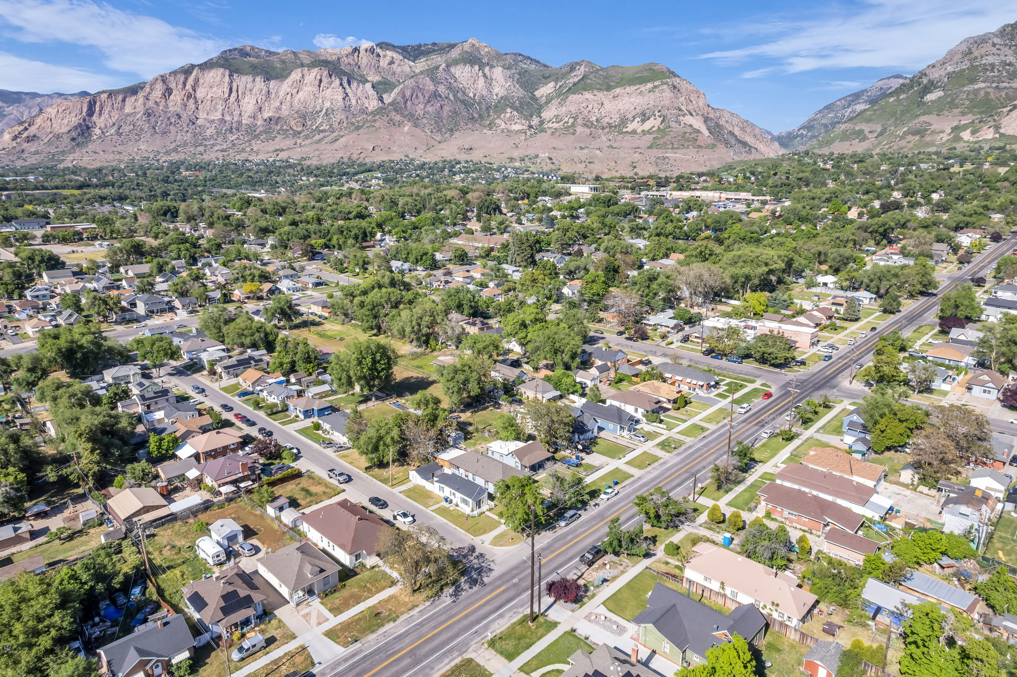 Aerial perspective showcasing a residential neighborhood with a backdrop of mountains