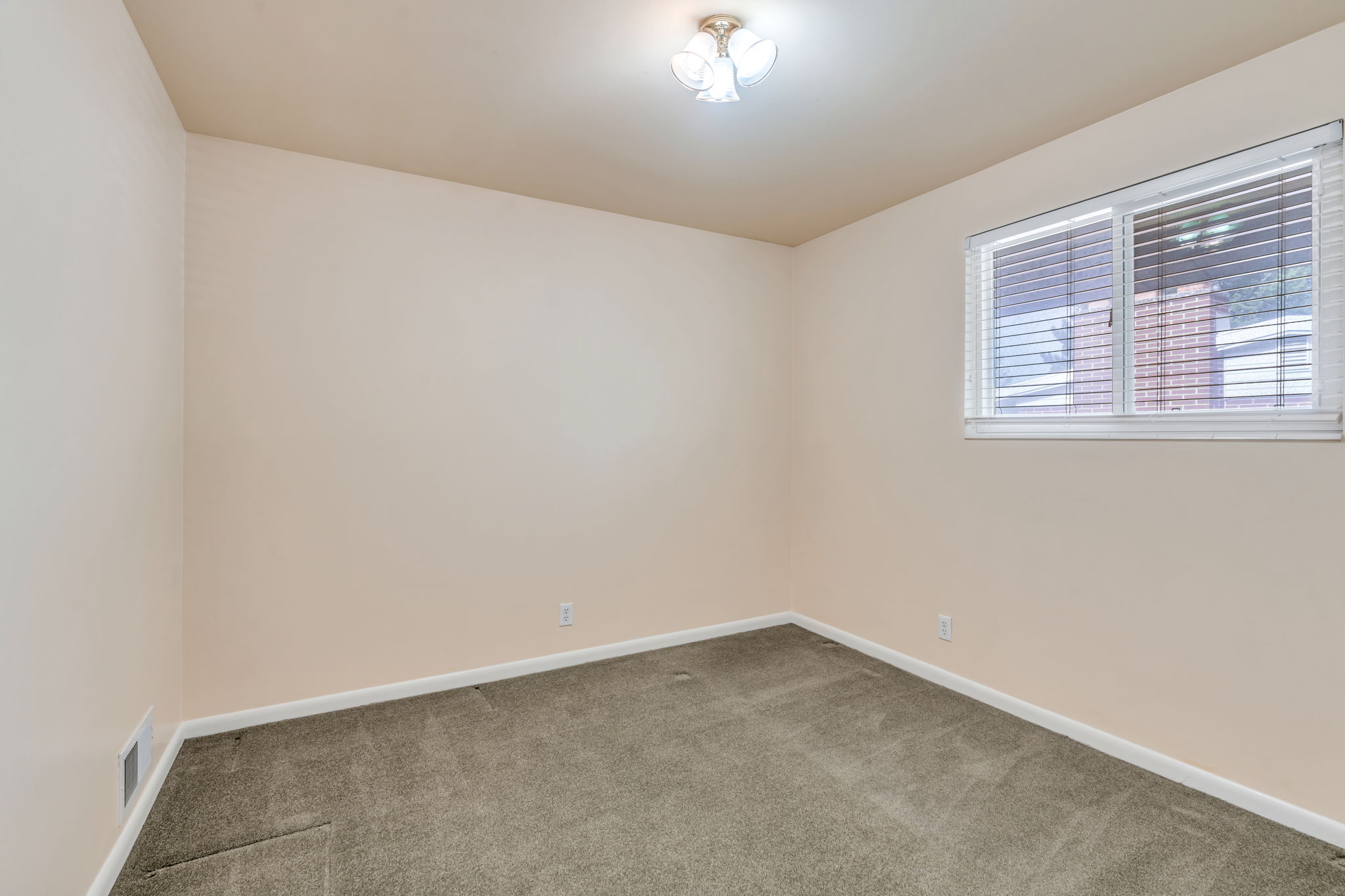 Neutral-toned walls complement the carpeted flooring