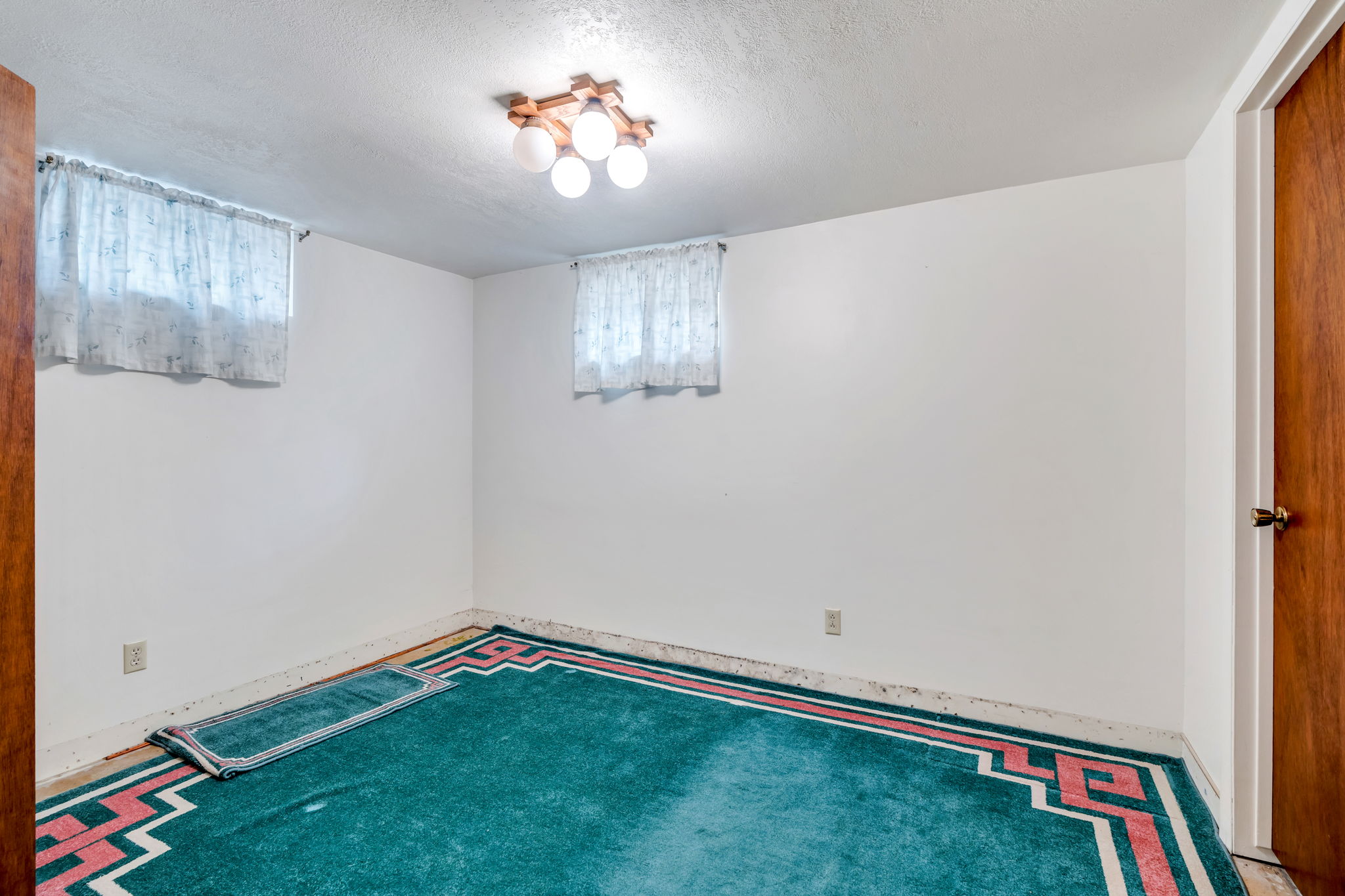 Room featuring white painted walls and a ceiling-mounted light fixture