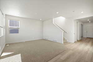 **Disclaimer**  Interior package may vary. Open-concept living space featuring neutral paint, recessed lighting, and carpet flooring