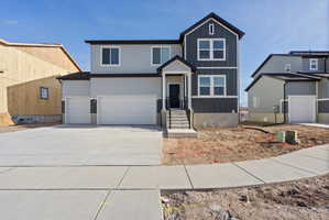Contemporary two-story residence with a gray and dark gray facade, featuring a prominent front porch