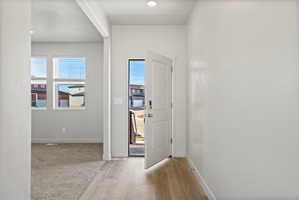**Disclaimer**  Interior package may vary. Entryway featuring wood-finish flooring, recessed lighting, and a white paneled door