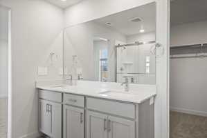 **Disclaimer**  Interior package may vary. Bathroom featuring a double vanity with light gray cabinetry and white countertops