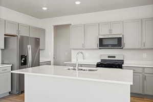 **Disclaimer**  Interior package may vary. Modern kitchen featuring a central island with an integrated sink and gooseneck faucet