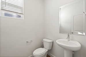 **Disclaimer**  Interior package may vary. Pedestal sink with chrome faucet, large framed mirror, and toilet with chrome paper holder