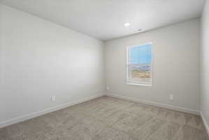 **Disclaimer**  Interior package may vary. Room featuring light gray wall paint, gray carpet, a single window with white blinds, white trim, and a recessed ceiling light