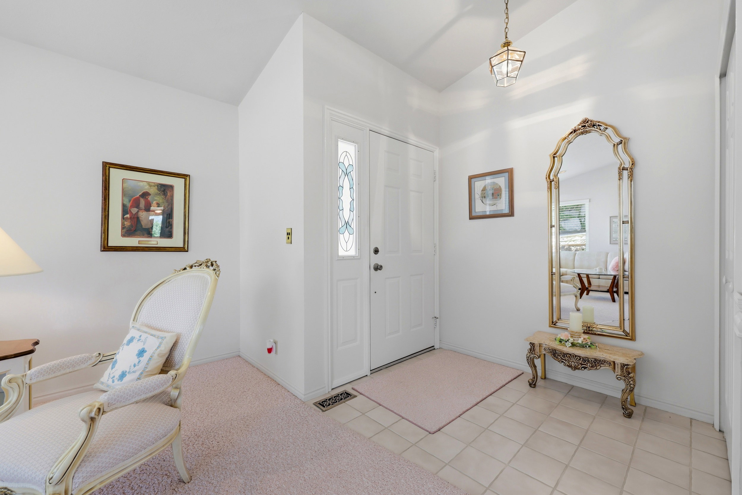 Entryway featuring a decorative front door with an ornate glass insert and a complementary sidelight