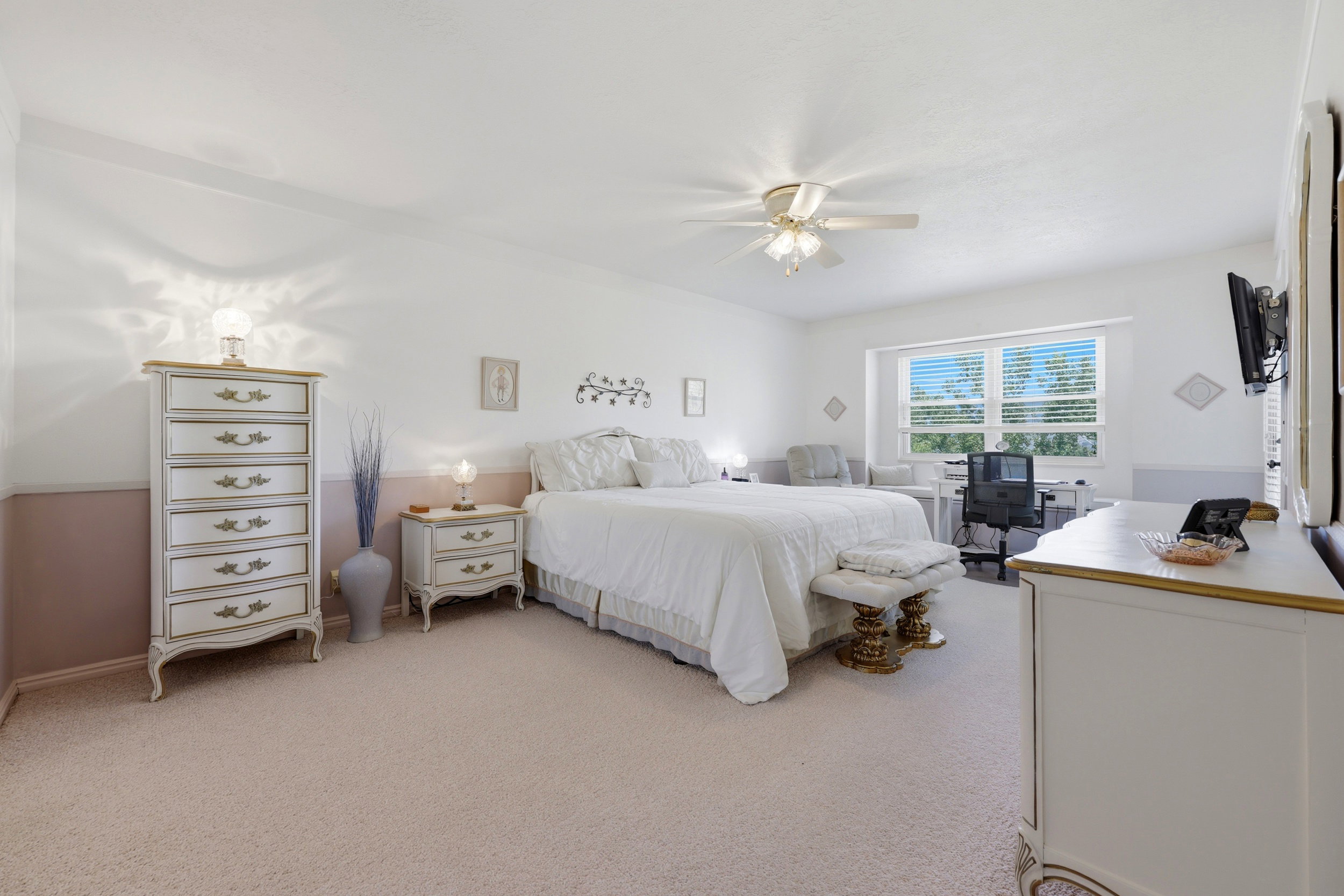 Spacious room featuring light-toned carpet flooring and a neutral color palette