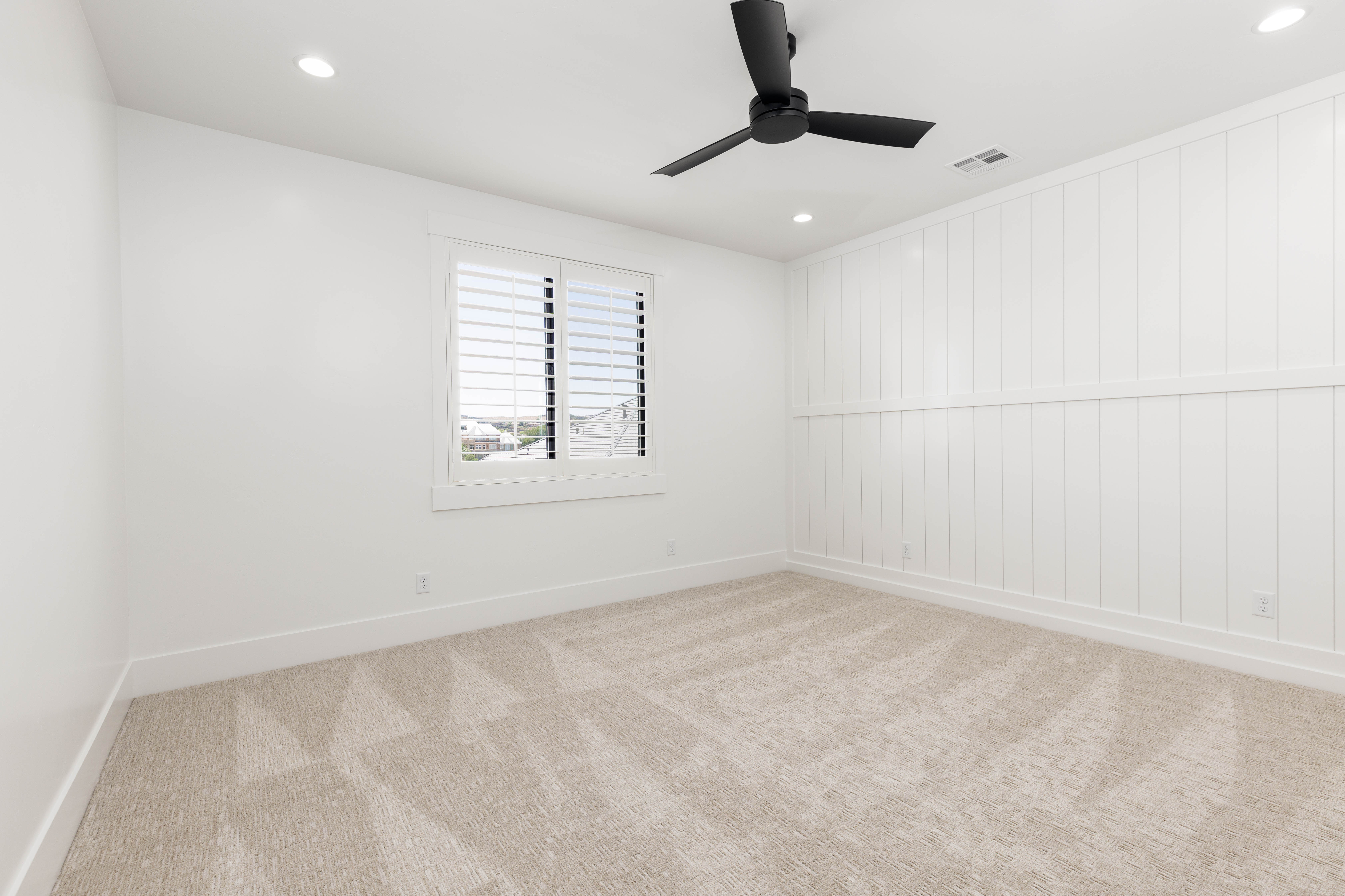 Neutral-toned carpet flooring complements the white walls and trim