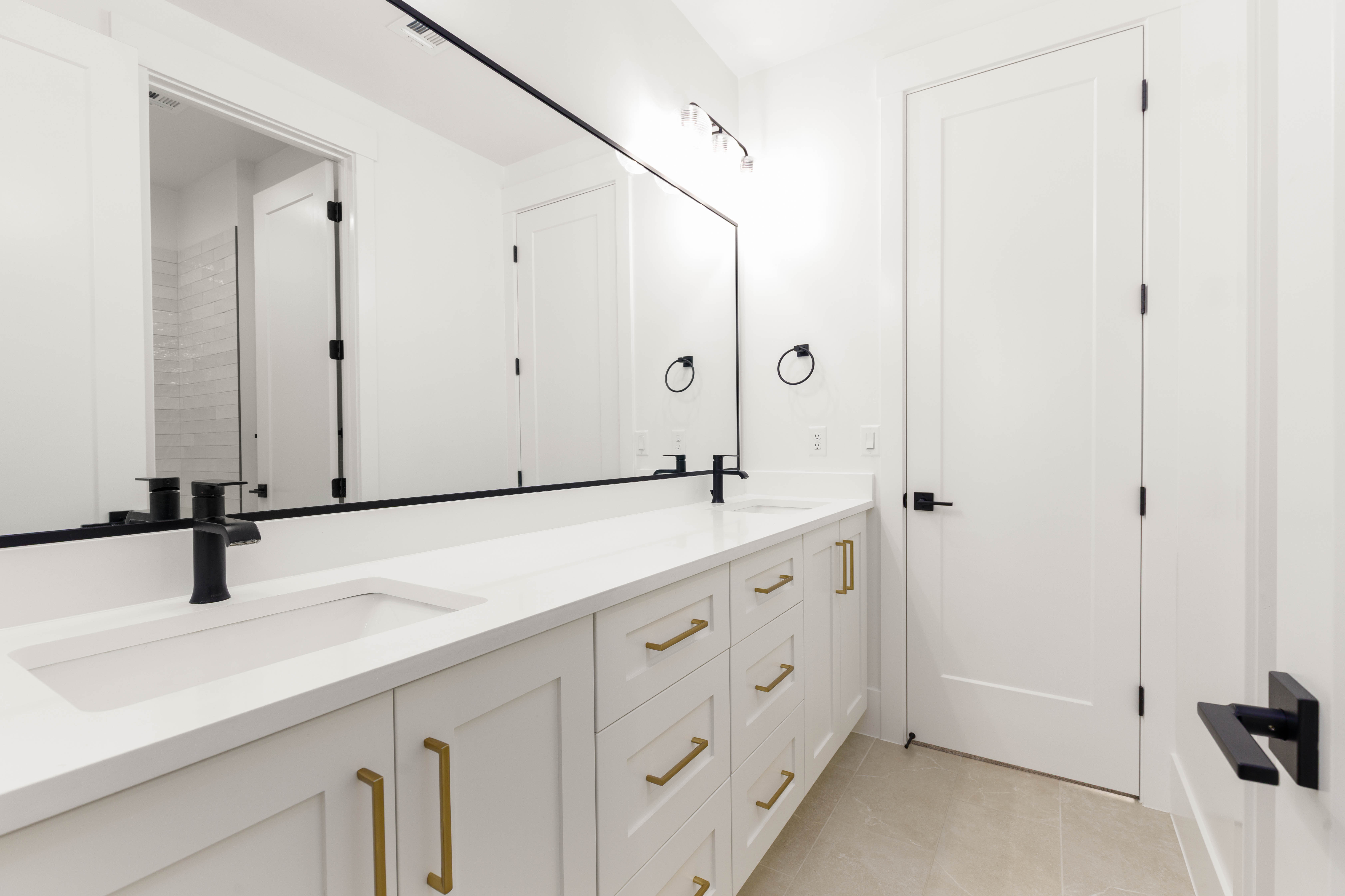 Double vanity with white cabinetry and integrated sinks
