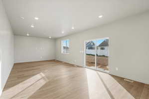 Spacious interior with neutral wall tones and wood-finish flooring